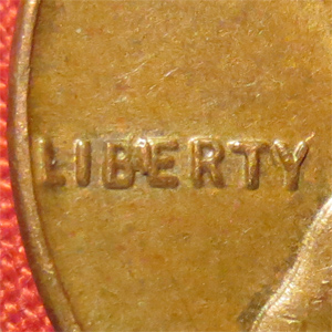 1933 Lincoln Wheat Penny BIE error close-up showing raised die crack between B and E in LIBERTY creating LIBIERTY appearance